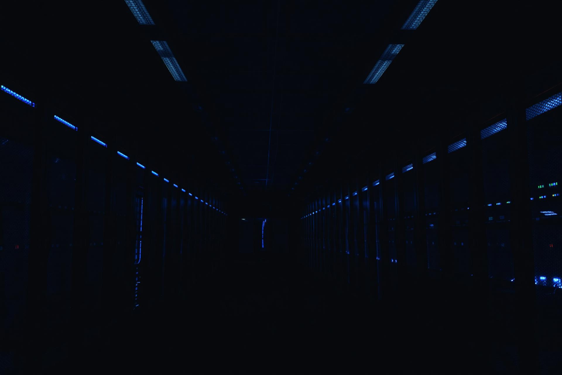 Dark data centre hall with deep blue ambient lighting